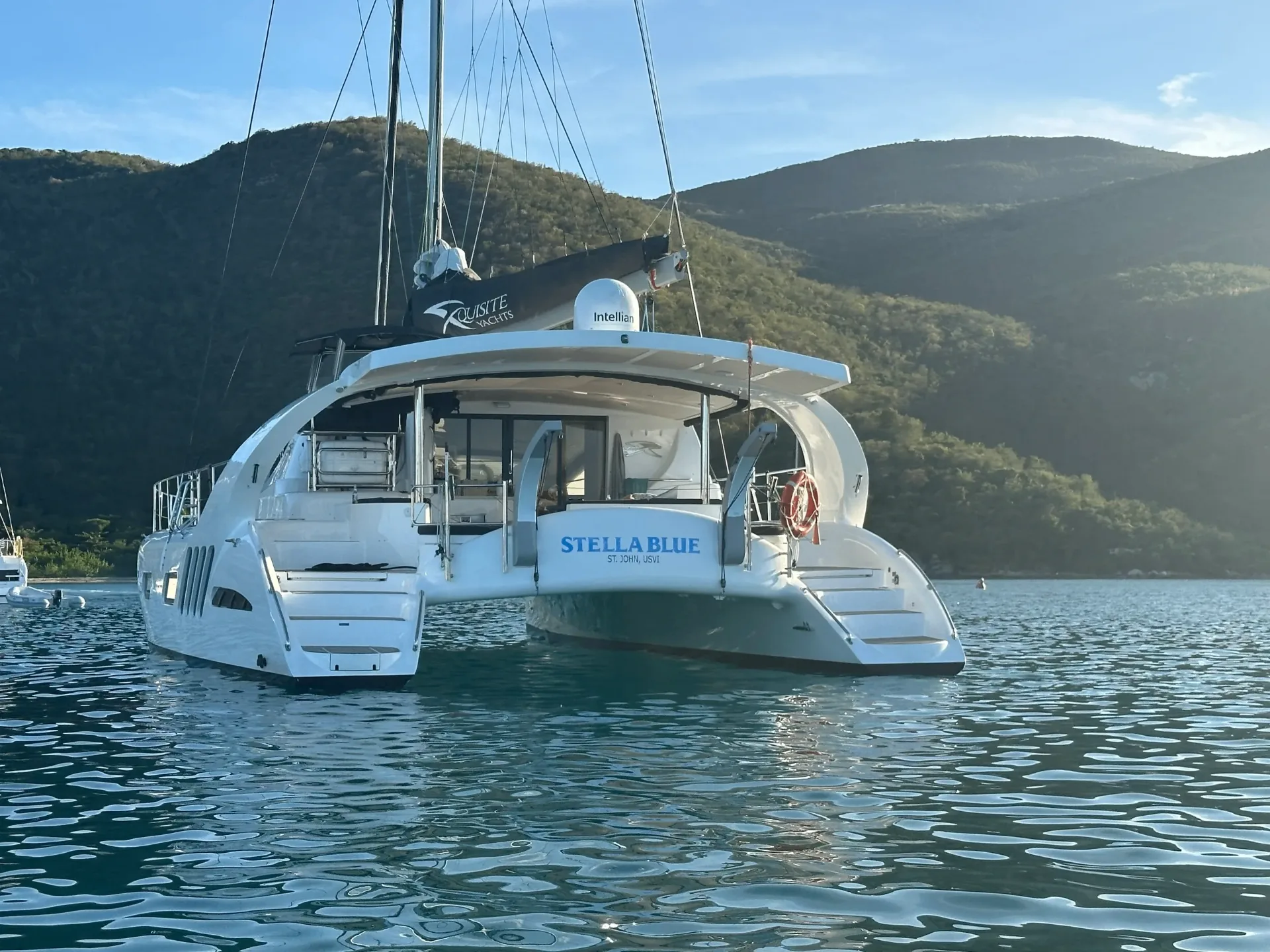 Stern and swim platform of Stella Blue catamaran anchored in a quiet USVI cove